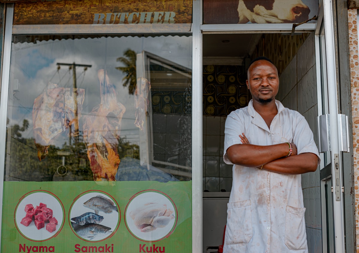Small business owner standing outside his shop